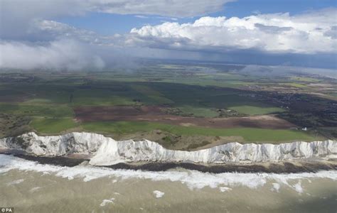 Huge Section Of White Cliffs Of Dover Falls Into The Sea Just Yards From Row Of Beach Front