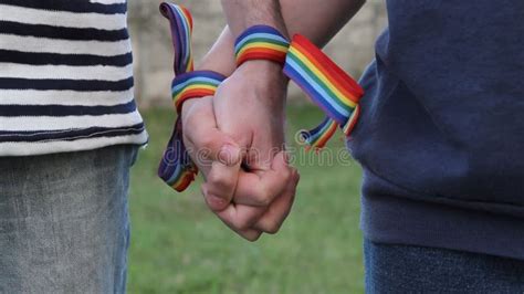 Hands With Rainbow Lgbt Ribbons On The Wrists Gay Couple Gently Holds