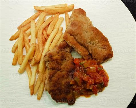 breaded wiener schnitzel with side dishes 24056332 Stock Photo at Vecteezy