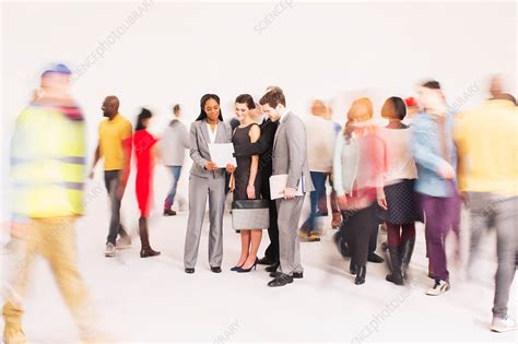 Bustling crowd around business people - Stock Image - F014/6743 ...