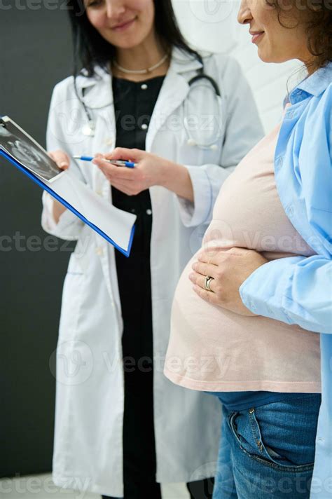 Cropped View Pregnant Woman Holding Hand On Her Big Belly While Doctor