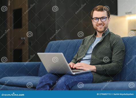 Young Cheerful Man Sitting On Sofa With Laptop Stock Image Image Of