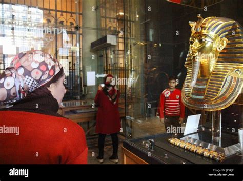 A Visitor Looks At The Restored Gold Mask Of King Tutankhamun At The