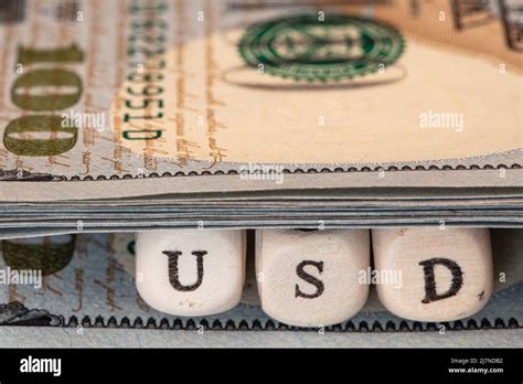 Usd Word Written On Wooden Blocks On 100 Dollar Banknote Background For