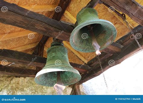 Two Large Rusty Church Bells In The Bell Tower Of An Old Cave Church