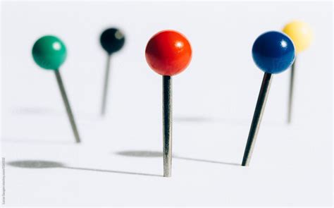 A Bunch Of Push Pins In A White Foam Board By Stocksy Contributor