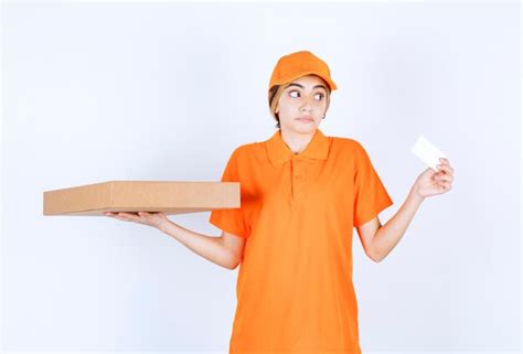 Premium Photo Female Courier In Orange Uniform Holding A Cardboard