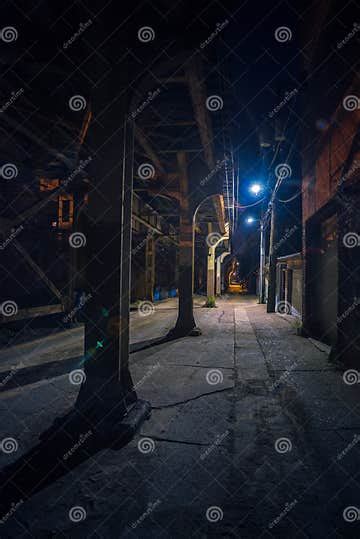 Dark And Scary Downtown Urban City Street Alley At Night Stock Photo