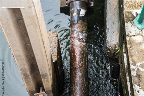 Water Splashing From Broken Old Galvanized Iron Water Pipe Stock Photo