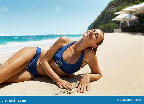 Woman Body In Summer Girl In Bikini Tanning On Beach Stock Photo