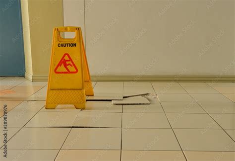 Closeup Buckled And Broken Tiles On Corridor Near Elevator With A