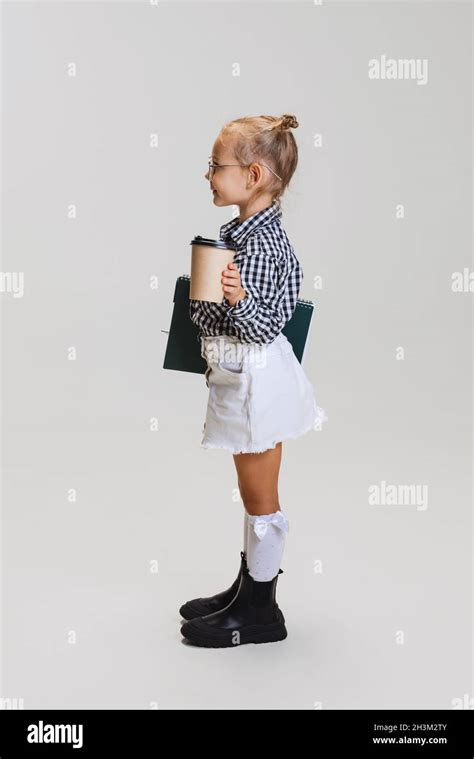 Full Length Side View Portrait Of Little Cute Girl Child With Notebook