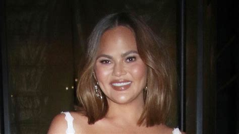 Chrissy Teigen Shows Off Her Toned Legs In White Minidress As She