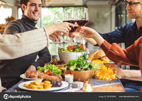 Group Young People Celebrating Christmas Party Dinner Clinking Glass