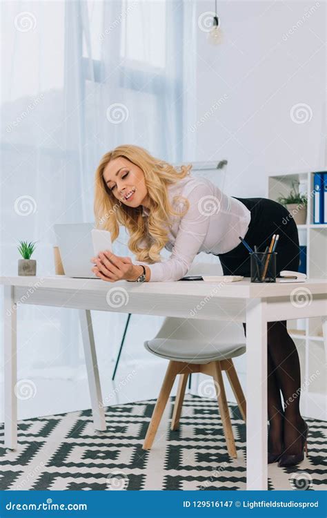 Attractive Businesswoman Leaning On Table And Taking Selfie Stock Image