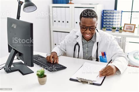 Young African Man Working As Doctor At Medical Clinic Stock Photo