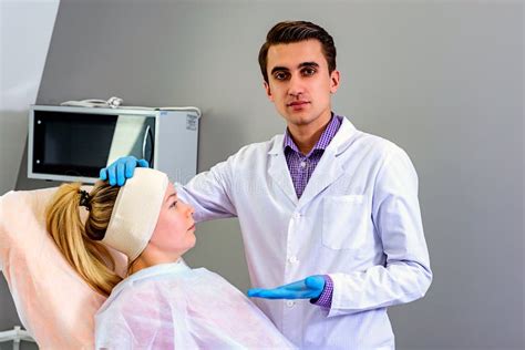 Plastic Surgery Doctor Patient Inspection And Consultation Stock Photo