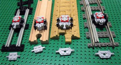 lego train tracks and track cars on a green surface