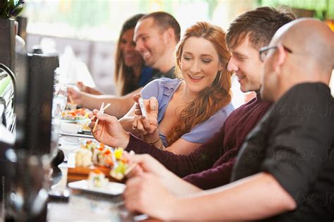 "Sushi: Woman Shows Friend Photo Of Lunch" by Stocksy Contributor "Sean ...