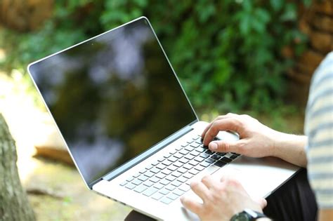 Premium Photo | Young man with laptop outdoors