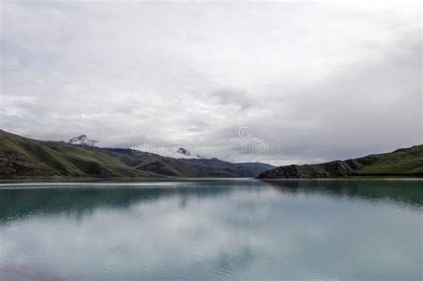 There Is A Quiet Blue Beautiful Lake At The Foot Of The Mountain Stock