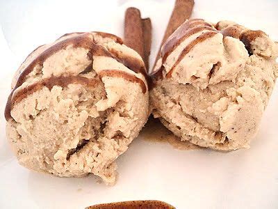 Two Ice Cream Sandwiches On A White Plate With Cinnamon Sticks Sticking