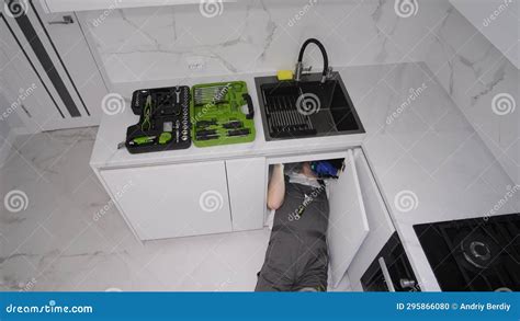 Male Plumber Cleaning Pipes. Clean the Drain and Sink Stock Photo ...