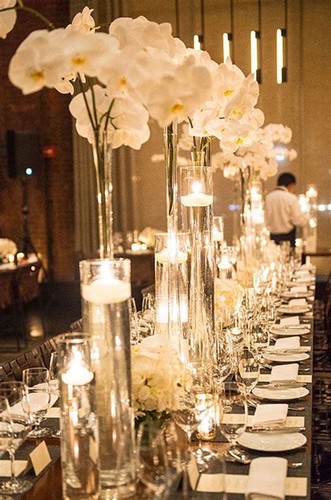 Orchids And Floating Votives In Varying Heights Come Together For A