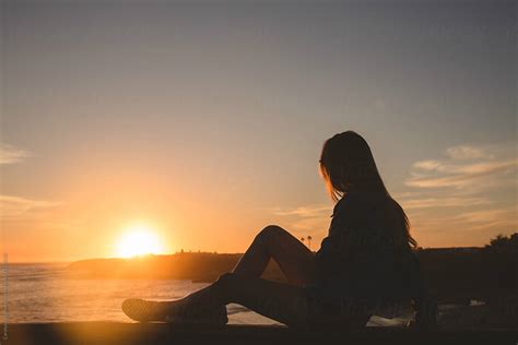 «teenage Girl Sitting On A Fence Watching The Sunset Del Colaborador