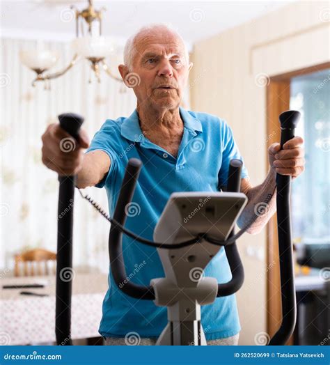 Male is Working Out on Elliptical Machine for Elder Healthy Concept