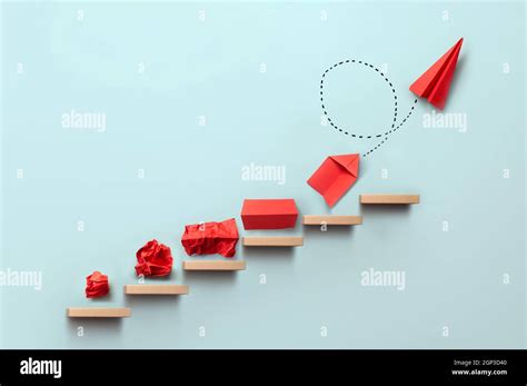 Wooden steps with different stages of making a paper airplane, creating ...