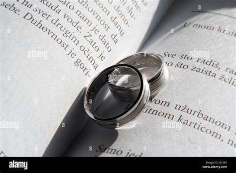 White gold ring. Wedding rings in a book Stock Photo - Alamy