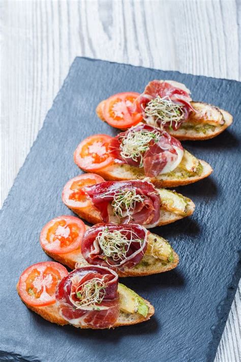 Appetizer Bruschetta With Prosciutto Tomato Zucchini On Ciabatta