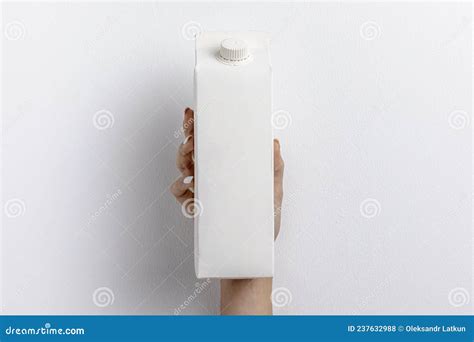 Front View Hand Holding Simple Milk Carton High Quality Photo Stock