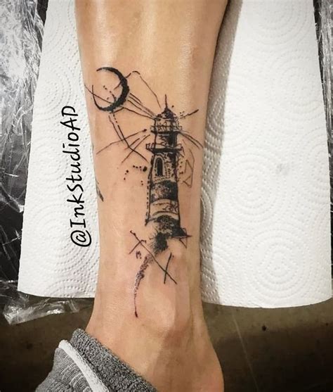 A Small Lighthouse Tattoo On The Ankle Is Shown In Black And Grey Ink