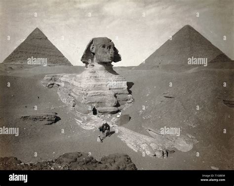 The Great Sphinx Partially Excavated With Two Pyramids In Background