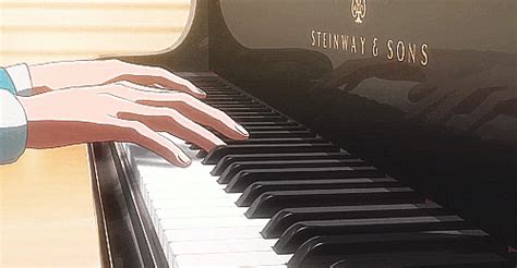 a person's hand on the keys of a piano