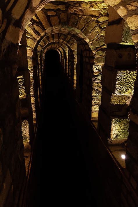 Dark Creepy Hallway in the Catacombs Photograph by John Twynam