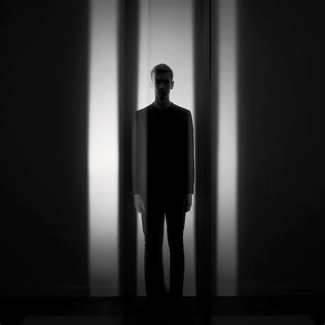 Premium Ai Image A Man In A Dark Room With A Man Standing In The Doorway