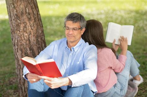 Premium Photo Mature Man And Woman Reading Books Together While