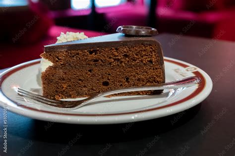 Piece of famous Sachertorte chocolate cake with apricot jam of Austrian ...