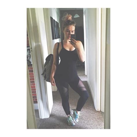 A Woman Is Taking A Selfie In The Mirror Wearing Leggings And Running Shoes