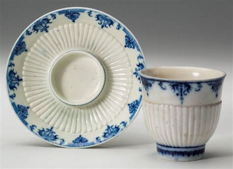 Two Blue And White Porcelain Cups Sitting Next To Each Other