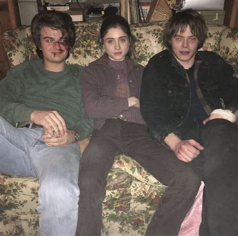 Three People Are Sitting On A Couch Together