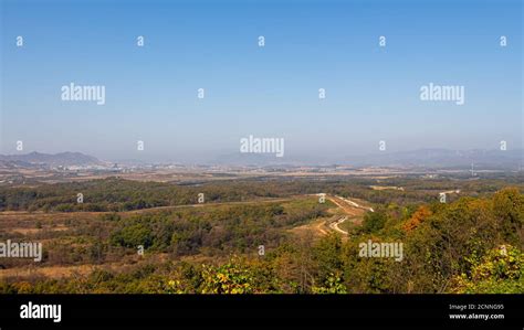 The border fence running through the Korean DMZ from South Korea, with ...