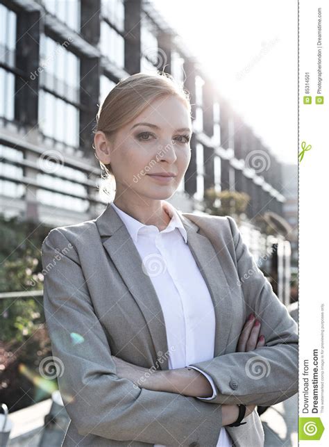 Portrait Of Confident Businesswoman Standing Arms Crossed Outside Office Building Stock Image