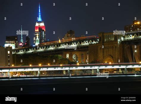 A night view of the NYC skyline, roads and bridges at night with lights ...