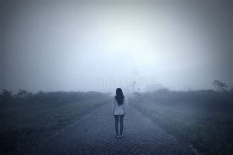 Sad Woman Standing Alone In A Misty Morning Stock Photo Image Of