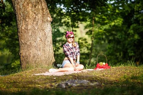 Premium Photo Beautiful Young Girl In A Plaid Shirt And Short Denim Shorts In Pinup Style In