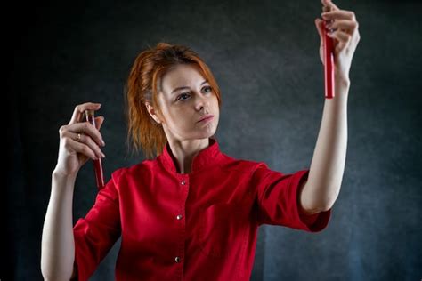 Premium Photo Woman Lab Assistant In Red Uniform Hold Blood Sample In